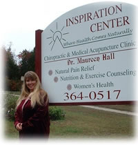 Dr. Hall in front of the Inspiration Center Sign